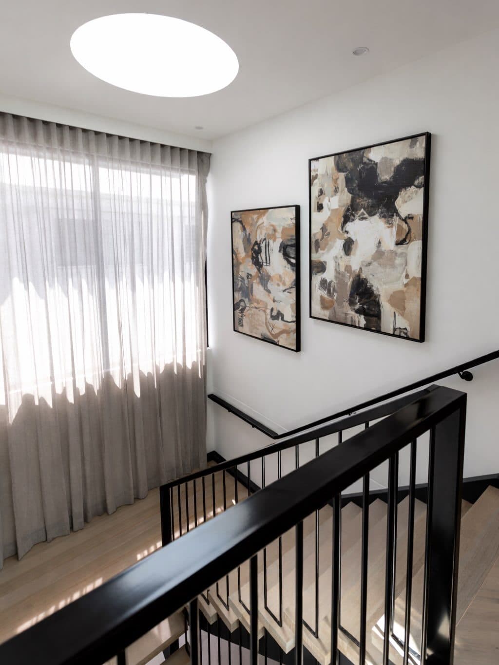 Landing detail — the balustrade turning the corner under a skylight