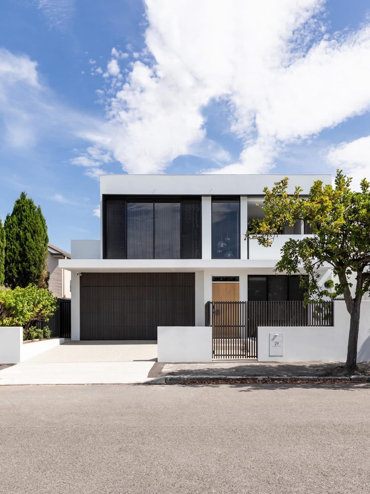 Front facade — dark glazing against white render