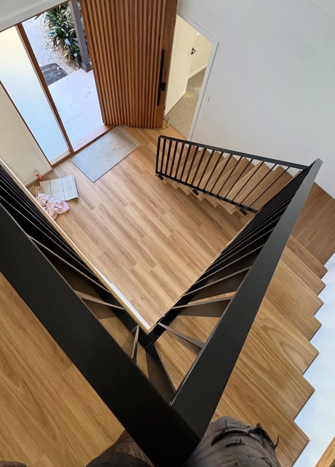 Looking down the stair — steel, timber and daylight