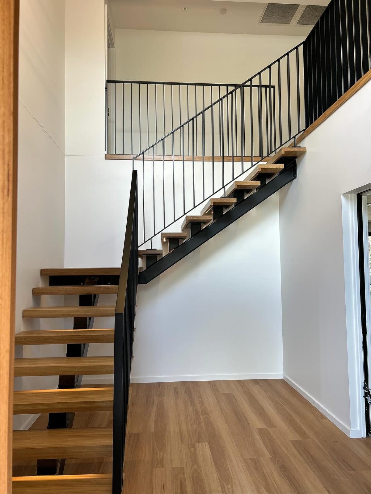 The landing balustrade meeting the upper floor
