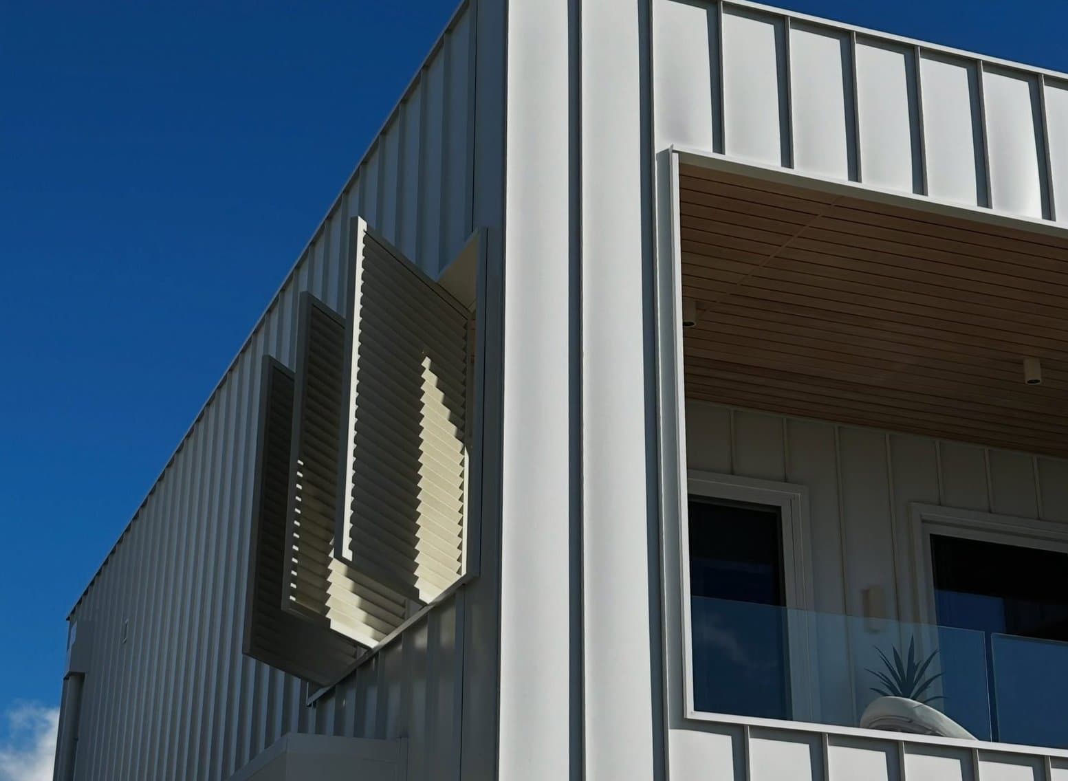 Vertical-board facade with the screened balcony