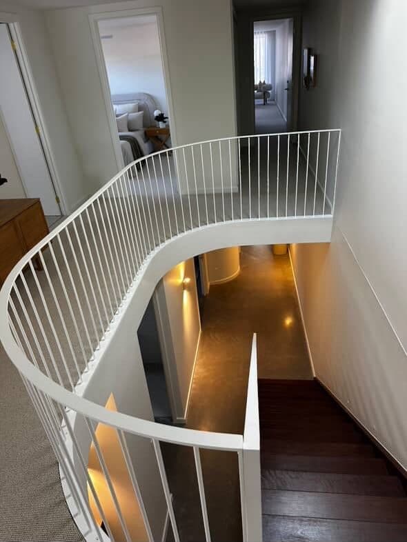 Curved white balustrade over the stair void