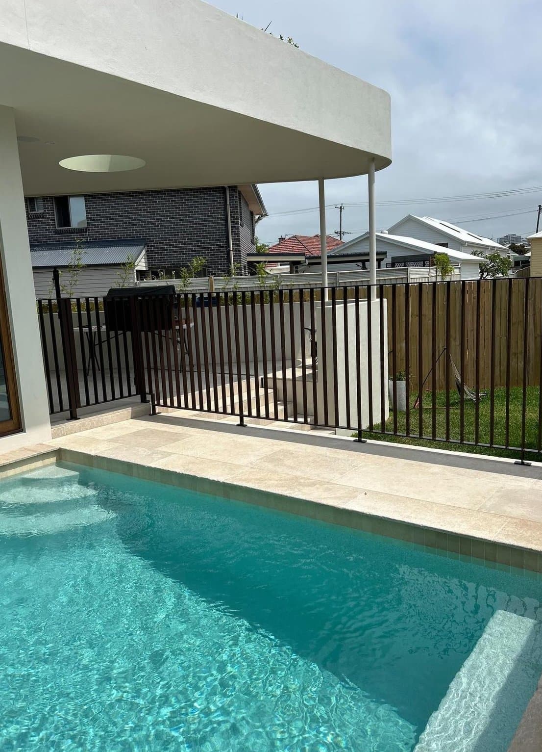 Pool behind the dark aluminium fence