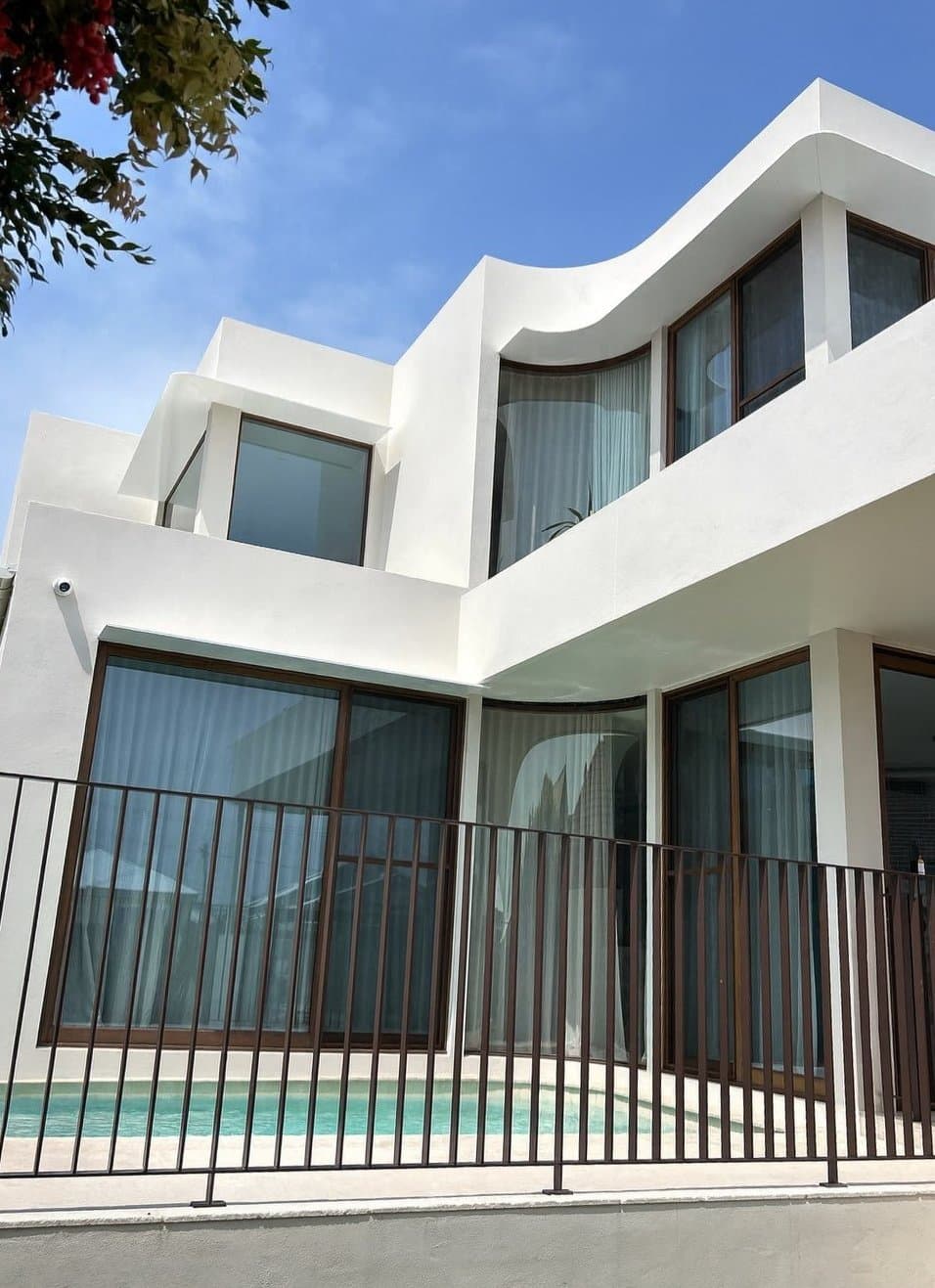 Pool fence and gate against the curved white walls