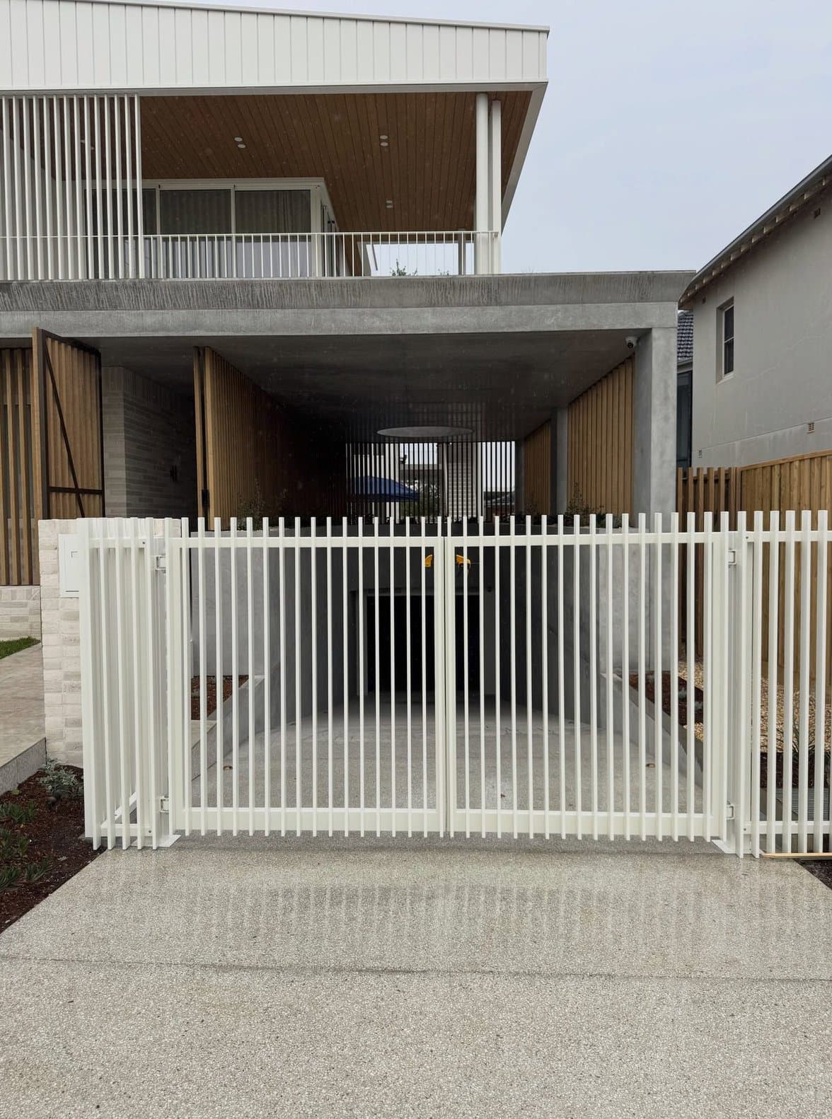 White picket-style gate and carport frontage
