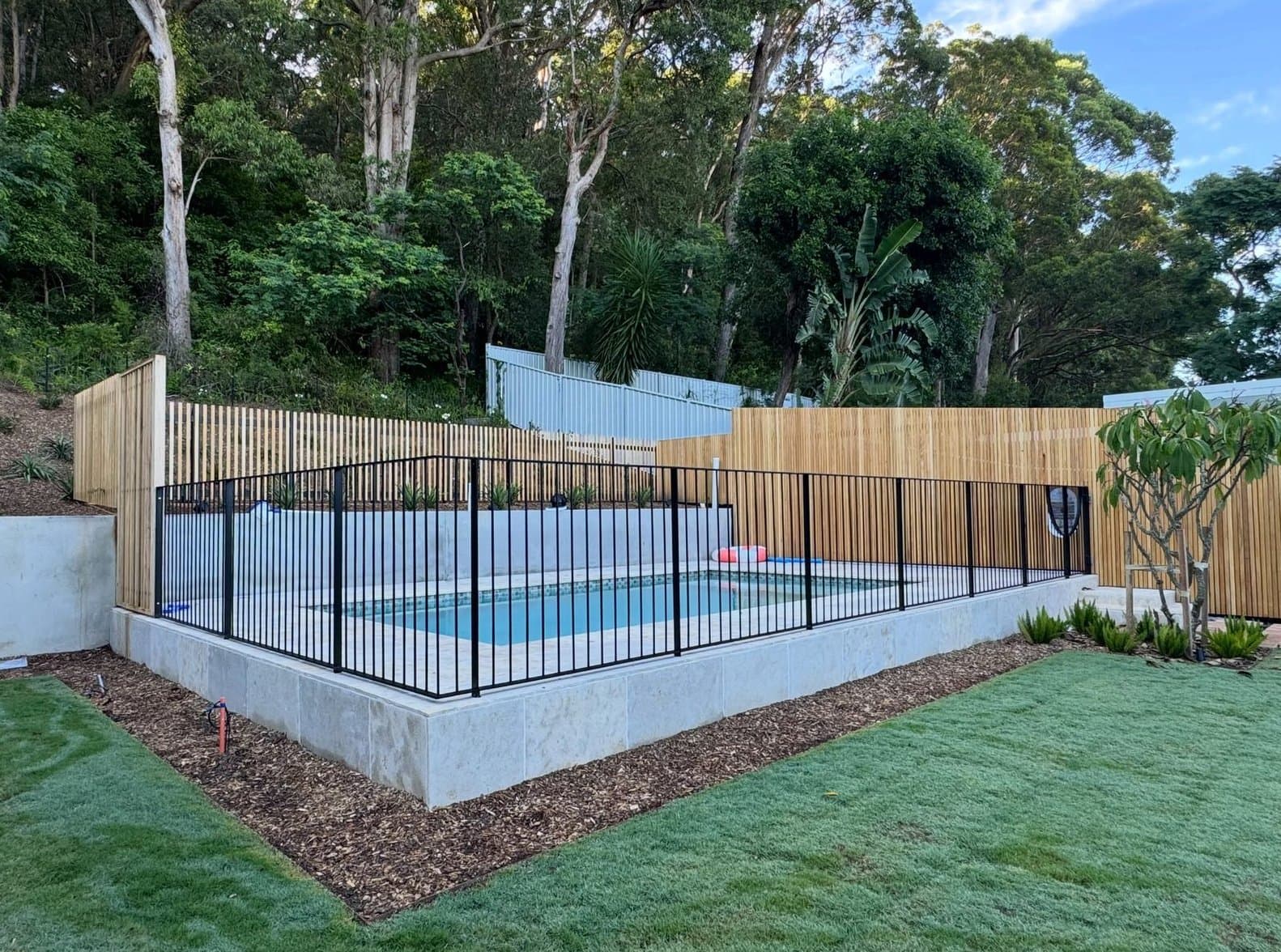 Black pool fence against the timber batten wall — Saratoga